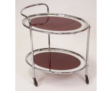 A mid-20th century tubular chrome oval two-tier drinks trolley, with coloured mirror glass insets, raised on roller castors, 