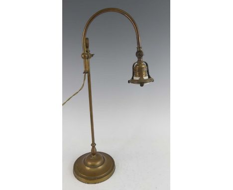 A 1920s brass adjustable desk lamp, with arched branch arm and rise-and-fall action, to domed spreading circular foot (lackin