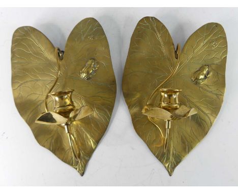 A pair of Arts &amp; Crafts brass wall sconces, each of lily-pad form with attendant raised frog and fly detail, with stylise