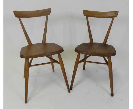 Two 1960s Ercol blond elm child's stacking chairs, each having single curved bar back, w.39.5cm