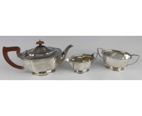 An Art Deco silver three-piece tea set, comprising; teapot, sugar and cream, each of elongated octagonal form with gadrooned 