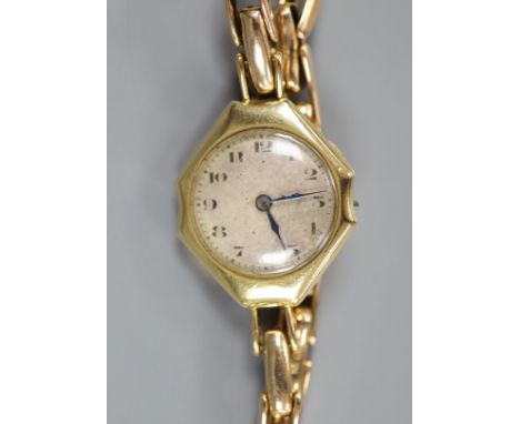   A lady's 18ct gold manual wind wrist watch(a.f.), on a 15ct expanding bracelet,gross weight 24.2 grams.