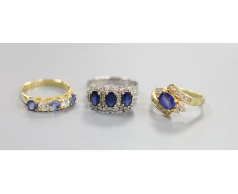   A modern 7560 white metal, sapphire and diamond set triple cluster ring, size Q/R and two other 18k, sapphire and diamond s