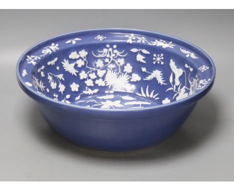   A large Chinese blue and white porcelain basin, lightly relief moulded with plants, 40cm