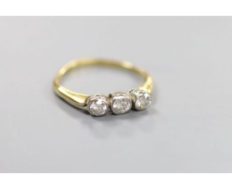   An 18ct and collet set three stone diamond ring, size R, gross weight 2.6 grams.