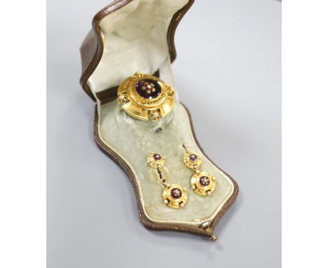  A cased continental Victorian style yellow metal, amethyst paste and seed pearl set demi parure, comprising a brooch and pa