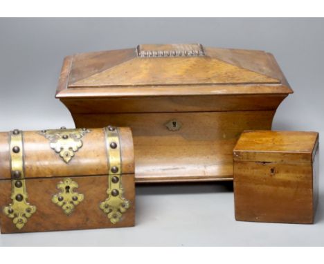   A Victorian rosewood sarcophagus tea caddy, 36.5 cm, a mahogany caddy and a Victorian Walnut and brass mounted casket
