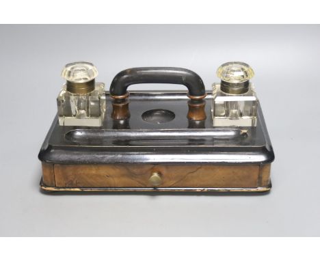   A Victorian walnut and ebonised desk stand with single drawer, 30cm wide together with a framed Continental porcelain portr