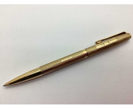 A 9ct Gold Yard-O-Led Ballpoint Pen, allover engine turned decoration, personalised 'M.C.' (EB, Birmingham 1973).