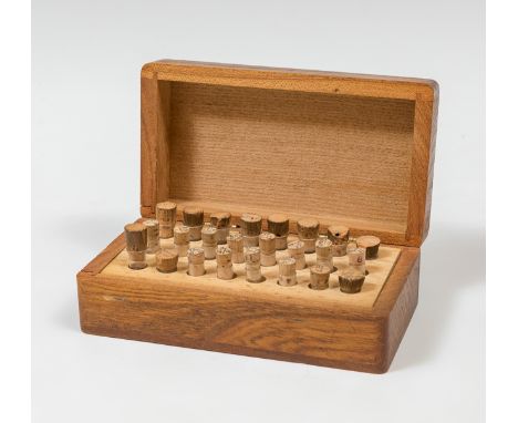 Case with calibrated machine rubies;Carved wood and glass.Synthetic and natural rubies.Measurements: 4,5 x 12,5 x 7 cm.This p