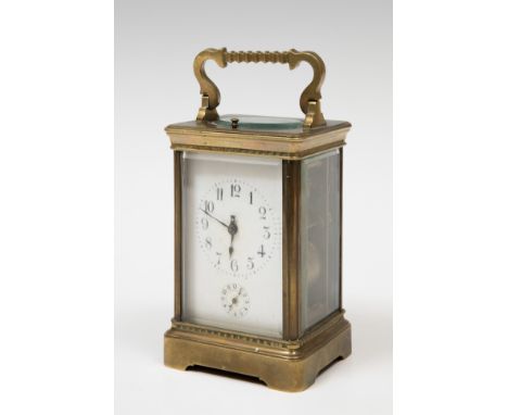 Travel clock; late 19th century.Bronze and bevelled glass.No key preserved.Measurements: 16 x 9.5 x 8 cm.Travel or carriage c