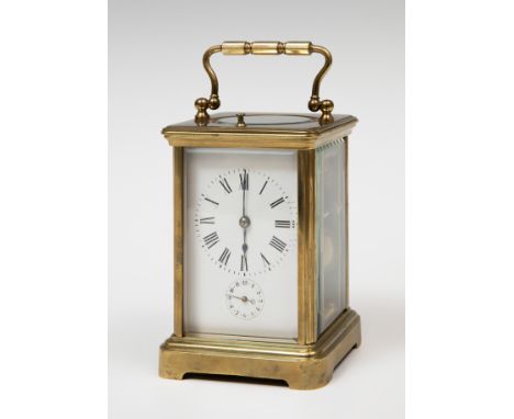 Travel clock; late 19th century.Bronze and bevelled glass.No key preserved.Measurements: 13 x 8.5 x 8 cm.Travel or carriage c