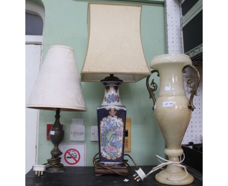 An Oriental blue and white lamp base with two other examples