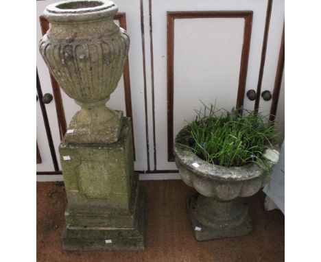 A cast urn on pedestal base with a cast tub garden planter on stand