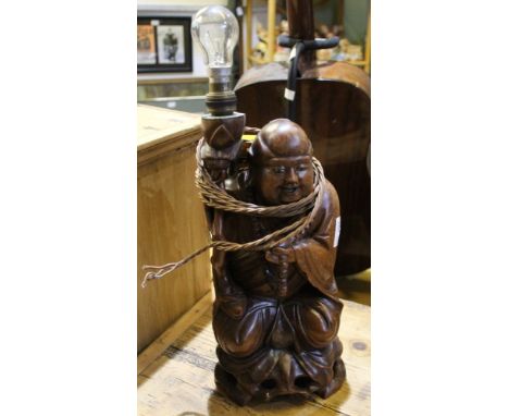 A carved wooden Buddha figure as a lamp base