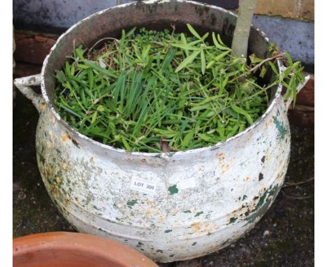 A cast metal circular garden planter