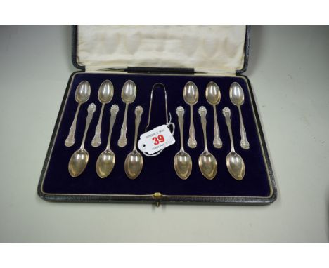 A cased set of twelve silver teaspoons and sugar tongs, by Josiah Williams & Co, London 1921, 143g.