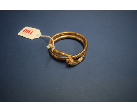 A 9ct gold articulated snake bangle, having ruby eyes and engraved head and tail, 31g all in.   Condition Report:  In clean o