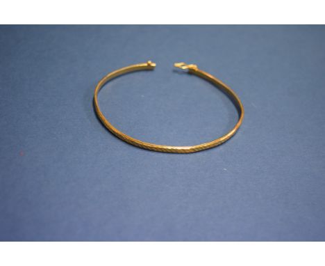A Chinese 22k gold bangle having engine turned decoration. 8.5g.   Condition Report:  Weight 8.5g