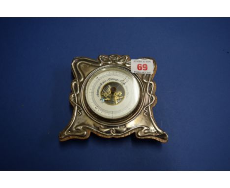 An Art Nouveau silver mounted aneroid barometer, by W V & S, Birmingham 1905, 12cm.   Condition Report:  some wear through to