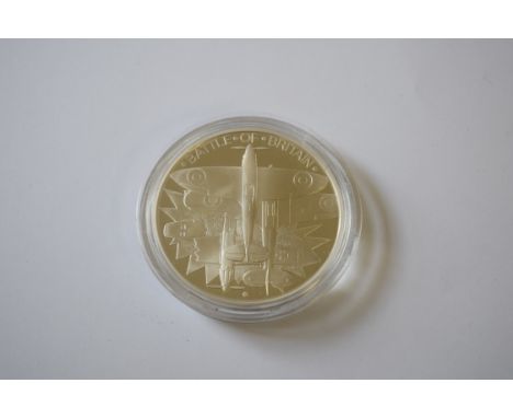 Two cased 1990 commemorative silver proof coins; together with a silver 1000 grain ingot; two commemorative silver pendants. 