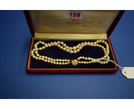 A double string of cultured graduated pearls with a 9ct gold and pearl cluster box clasp, with makers mark DHJ in a Mikimoto 