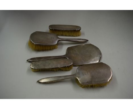 An engine turned silver five piece brush set, by William Neale & Son Ltd, Birmingham 1938.