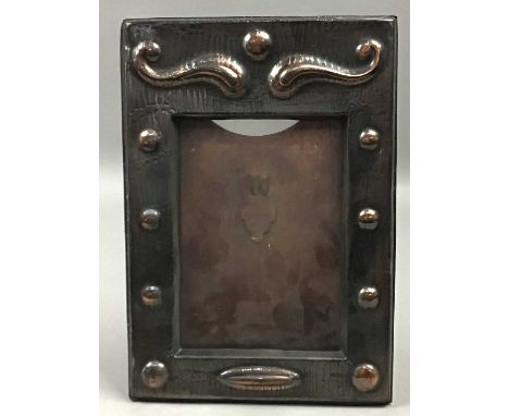 COPPER ARTS &amp; CRAFTS PICTURE FRAME,22cm x 15cm overall, along with a circular wall mirror, 30cm diameter, a brass oil lam