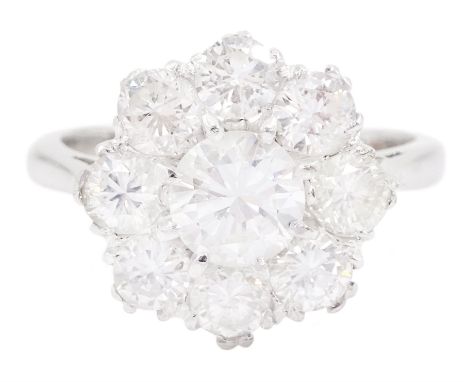 18ct white gold diamond cluster ring, a round brilliant cut diamond within a border of eight further smaller diamonds, the ce
