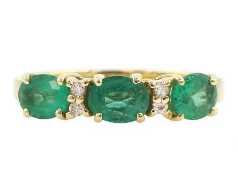 14ct gold emerald and diamond ring, three oval cut emeralds spaced by pairs of round cut diamonds, stampedCondition Report:Ap