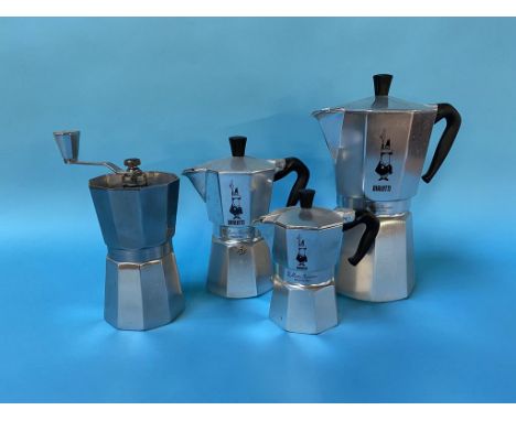 Three Bialetti coffee makers and a coffee grinder