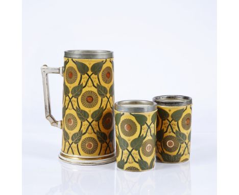 Manner of Christopher Dresser Old Hall tankard and two beakers, circa 1890 ceramic with silver plated rims, in a leaf and flo