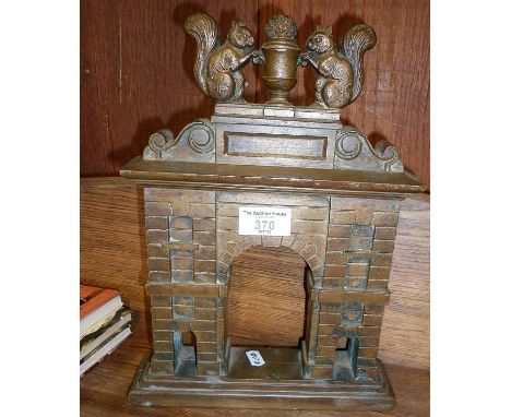 Heavy cast brass architectural model of an arch surmounted by squirrels and urn