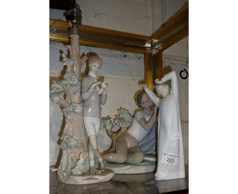 Lladro figure of a boy, a Lladro figure of a seated boy playing a pipe