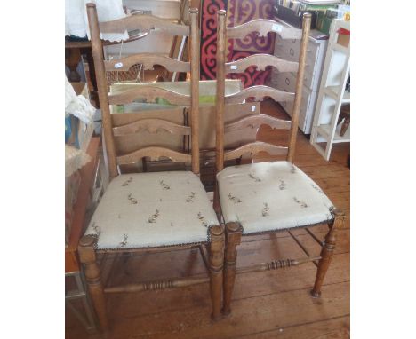 Pair of light oak ladderback dining chairs with seats upholstered in a rabbit print fabric