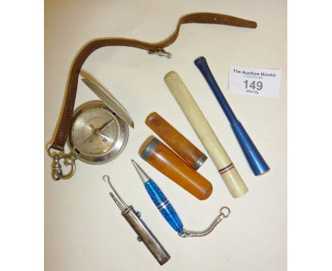 Amber and silver cigar or cheroot holders, other cigarette holders, a compass, a silver and turquoise combination Etui - prop