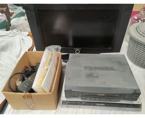 A vintage VHS player, DVD player and recorder and a tv 