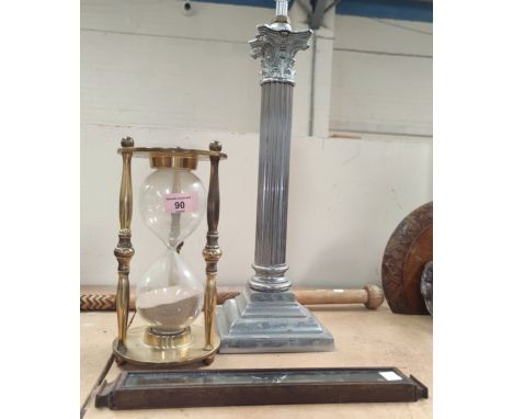 A chromed Corinthian column table lamp; a brass framed hourglass; a thermometer 