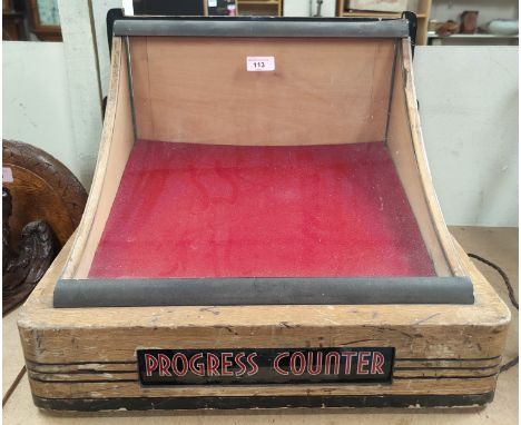 An Art Deco table top display cabinet in light oak and ebonised wood, concave glass display and light up "progress counter", 