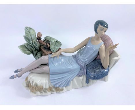 A Lladro group:  1920's girl on chaise longue with gramophone (a.f.) 
