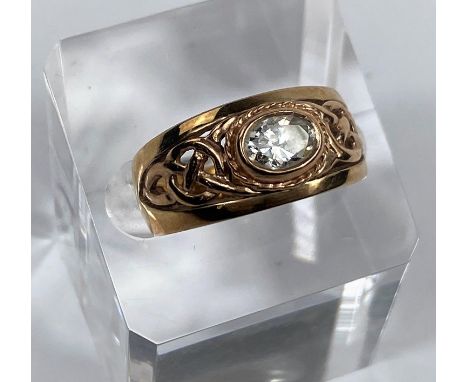 A 9 carat hallmarked gold period style ring set clear oval stone, the split shank with pierced decoration, 5.4 gm 