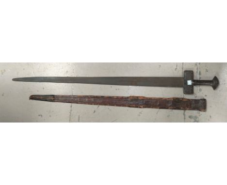 A 19th century Mid Eastern/Sudanese sword in embossed leather scabbard, overall length of sword 97cm 