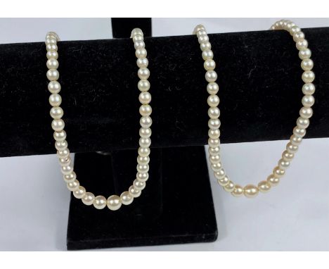 Two graduating pearl necklaces with white metal clasps 