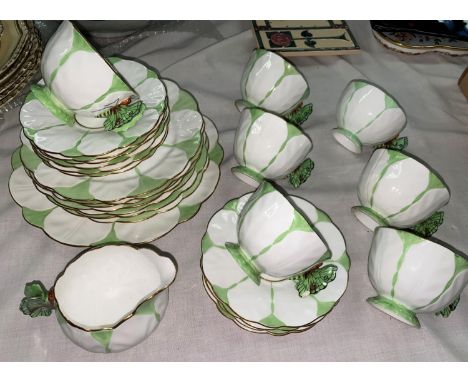 A 1930's Aynsley butterfly part tea service having 7 cups, 10 saucers, 7 side plates, a cake plate and a milk jug (some chips