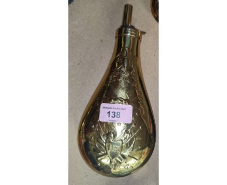 A large American brass powder flask with embossed trophy and eagle, 23cm 