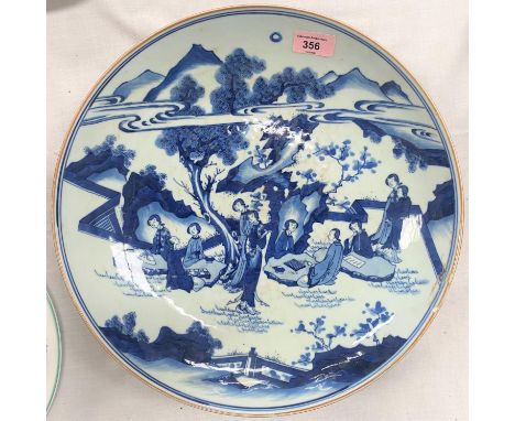 A large Chinese charger with traditional blue and white decoration, seal mark to base, d. 37cm (glaze heavily scratched and s