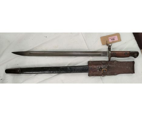 A British 1907 pattern Bayonet, wood sides to handle, steel mounted leather scabbard; blade 43cm. Marked 1907 S294 WSC. 