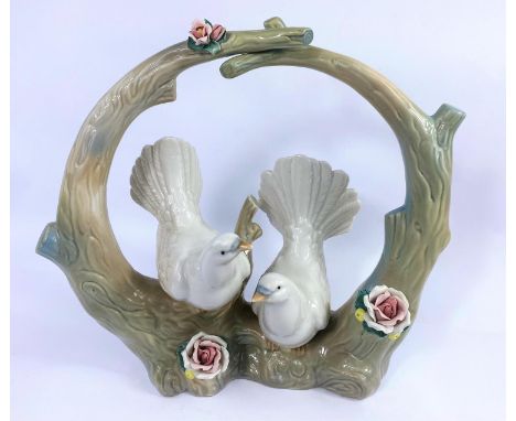 A Lladro style group:  2 doves in a bower, height 33 cm; a 1930's 'Sylvan' lustre jug; a Capodimonte floral encrusted vase 