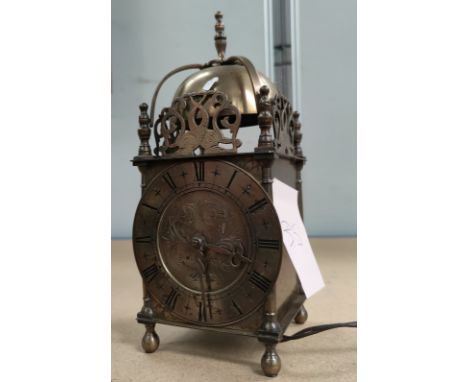 A selection of Alice in Wonderland characters in painted metal; a reproduction brass lantern clock with electric movement 