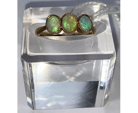 A yellow metal ring set 3 opals, stamped '18ct', 2.6 gm.&nbsp; Size M. The stones are a bit 'watery' particularly the centre 